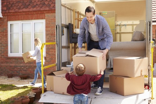 Trained movers using PPE while handling furniture in Colliers Wood