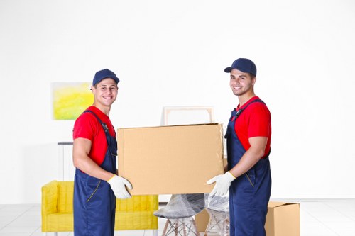 Removal van staff sorting recyclable household items in Colliers Wood