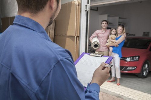 Removal team handling boxes and household items in South West London