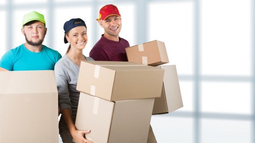 Professional movers handling packed boxes and fragile items