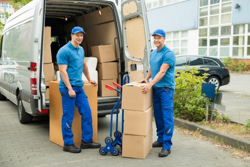 Prepared moving team handling boxes and furniture in Colliers Wood