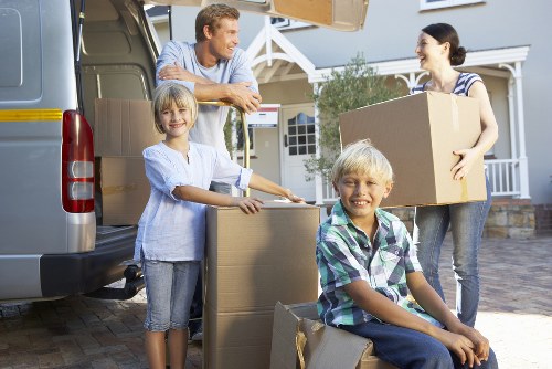 Packed moving boxes and furniture ready for transport in Colliers Wood